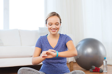 Image showing happy woman with heart-rate watch exercising