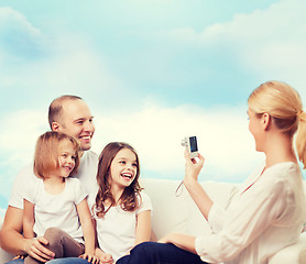 Image showing happy family with camera at home