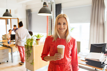 Image showing happy creative woman with coffee cup at office