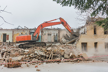 Image showing Demolition of a house with an orange digger