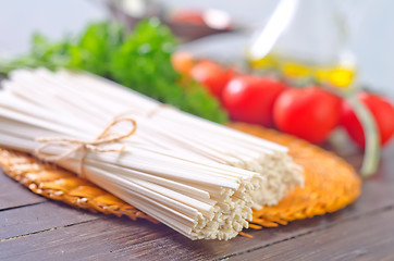 Image showing raw pasta and  tomato and sauce