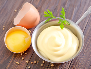 Image showing mayonnaise in metal spoon on wooden board