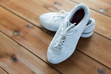 Image showing close up of sneakers on wooden floor