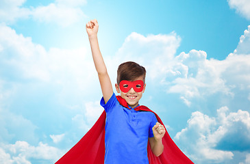 Image showing boy in red superhero cape and mask showing fists