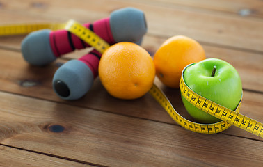 Image showing close up of dumbbell, fruits and measuring tape