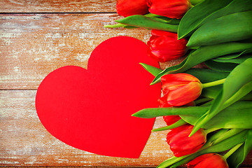 Image showing close up of red tulips and paper heart shape card