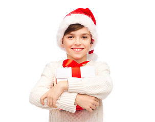 Image showing smiling happy boy in santa hat with gift box