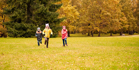 Image showing group of happy little kids running outdoors