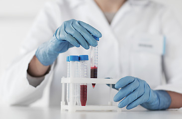 Image showing close up of scientist with tube making test in lab