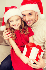 Image showing smiling father and daughter holding gift box