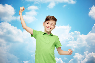 Image showing happy boy in polo t-shirt showing strong fists