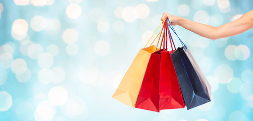 Image showing close up of female hand holding shopping bags