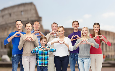 Image showing happy people showing heart hand sign over coliseum