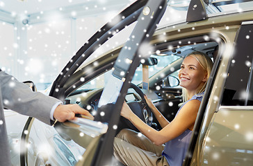 Image showing happy woman with car dealer in auto show or salon