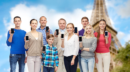 Image showing group of people with smartphones over eiffel tower