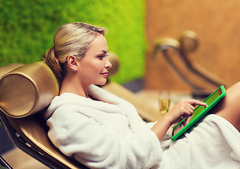 Image showing beautiful young woman with smartphone at spa