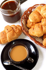 Image showing cup of coffee with fresh croissants