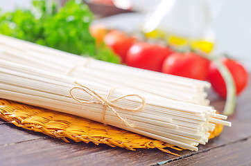 Image showing raw pasta and  tomato and sauce