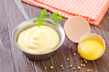 Image showing mayonnaise in metal spoon on wooden board