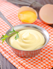 Image showing mayonnaise in metal spoon on wooden board