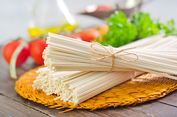 Image showing raw pasta and  tomato and sauce