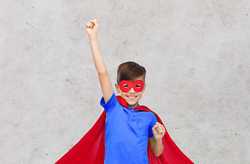 Image showing boy in red superhero cape and mask showing fists