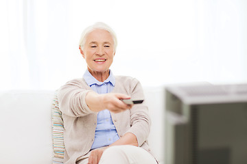 Image showing happy senior woman watching tv at home