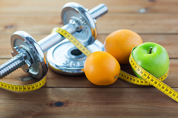 Image showing close up of dumbbell, fruits and measuring tape