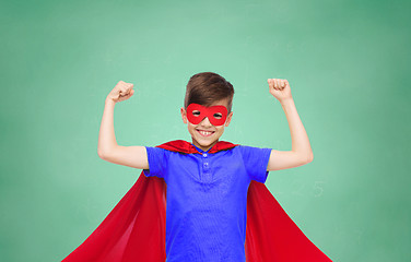 Image showing boy in red super hero cape and mask showing fists