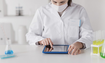 Image showing close up of scientist with tablet pc in laboratory