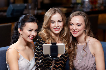 Image showing women with smartphone selfie stick at night club