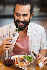 Image showing happy man having dinner at restaurant