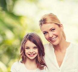 Image showing smiling mother and little girl