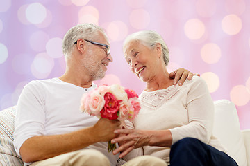 Image showing happy senior couple with bunch of flowers