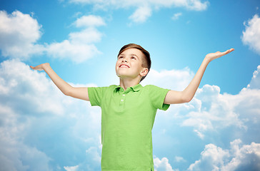 Image showing happy boy in polo t-shirt raising hands up