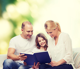 Image showing happy family with book at home