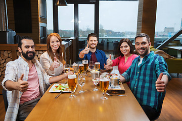 Image showing friends dining and drinking beer at restaurant