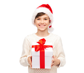 Image showing smiling happy boy in santa hat with gift box