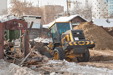 Image showing Tractor removes debris from building demolition