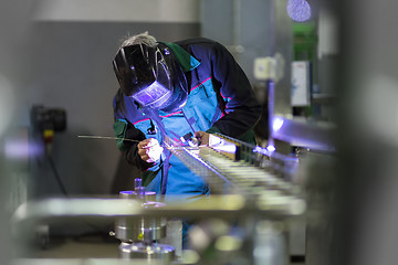 Image showing Industrial worker welding in metal factory.