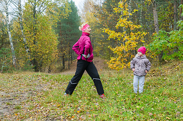 Image showing Woman with girl doing aerobics in the park