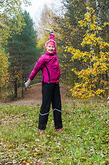 Image showing Wman is engaged in aerobics in the autumn park