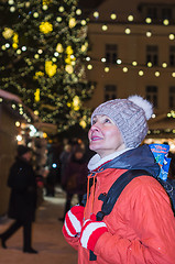 Image showing Woman looks at decorated Christmas Town Hall Square in Tallinn