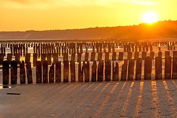 Image showing Sunrise over the Baltic Sea with groynes