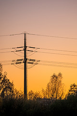Image showing sunset with afterglow and power mast
