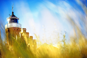 Image showing beach grass with old lighthouse