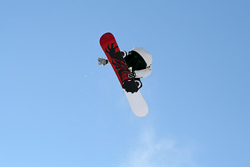 Image showing Snowboarder jumping high in the air
