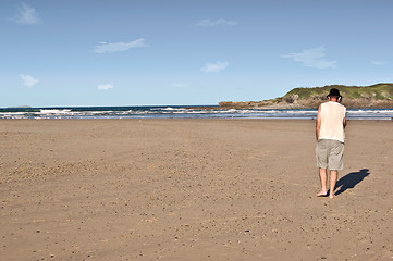 Image showing man on phone on beach