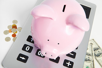 Image showing Pig bank and calculator