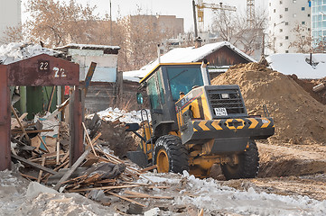 Image showing Tractor removes debris from building demolition